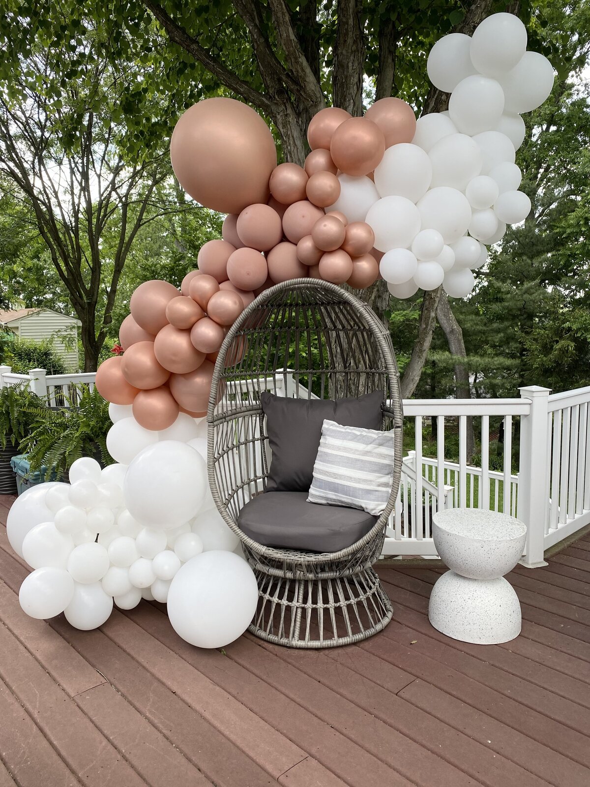 Engagement party balloon installation with egg chair