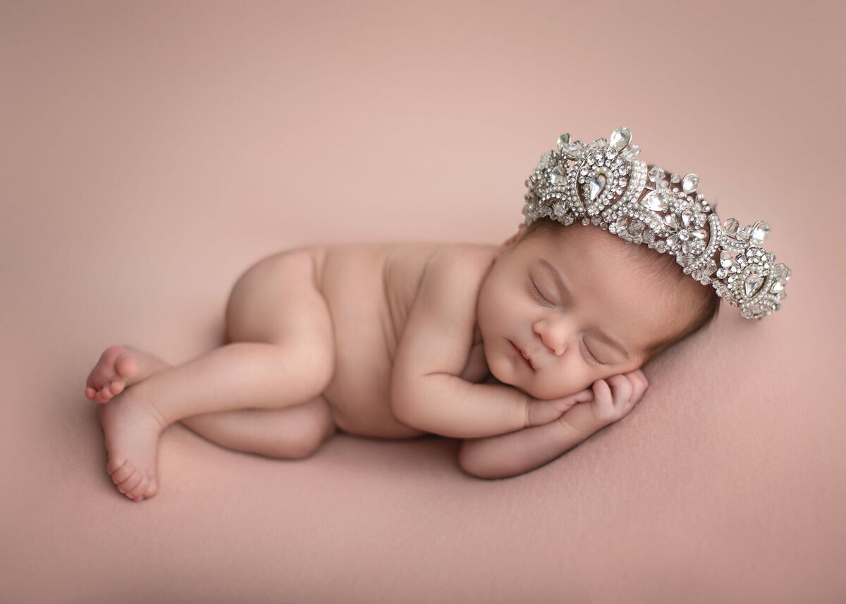baby on pink with tiara sleeping