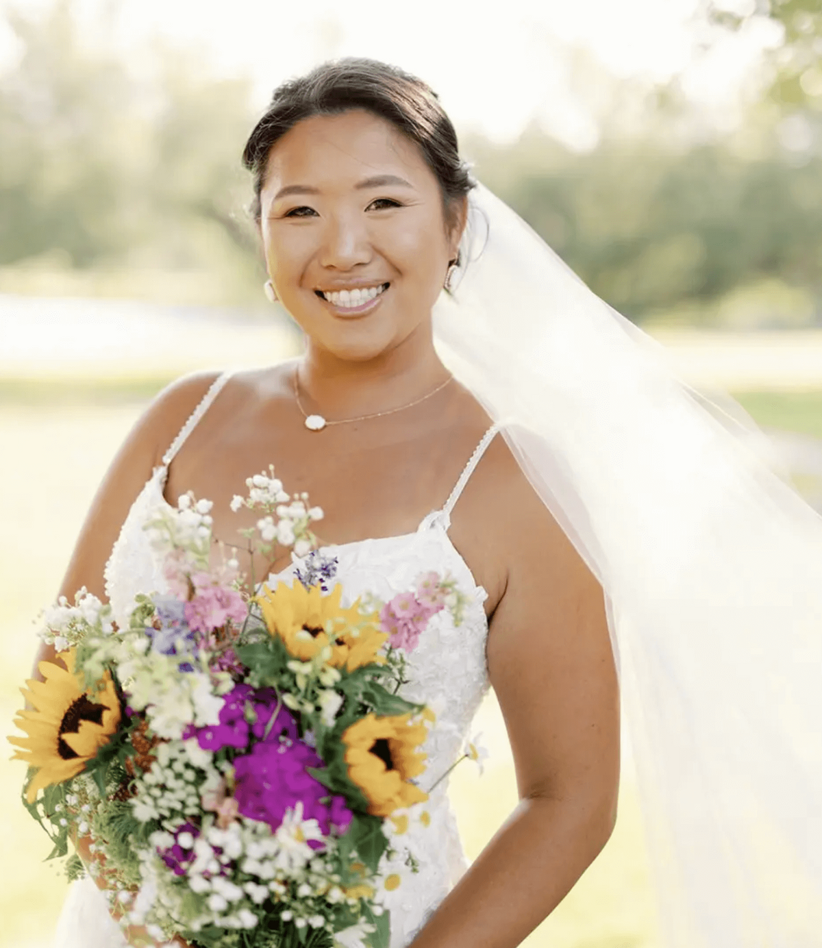 San Antonio bride glowing with natural makeup and soft bridal hairstyle, holding colorful sunflower bouquet on her wedding day