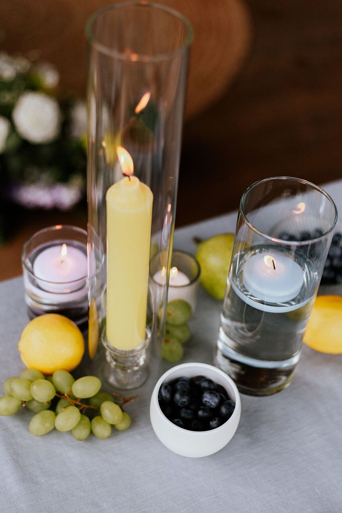 Wedding centerpiece with pillar candles and grapes