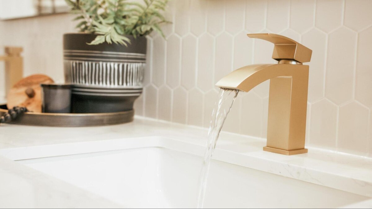 white bathroom sink with gold fixtures