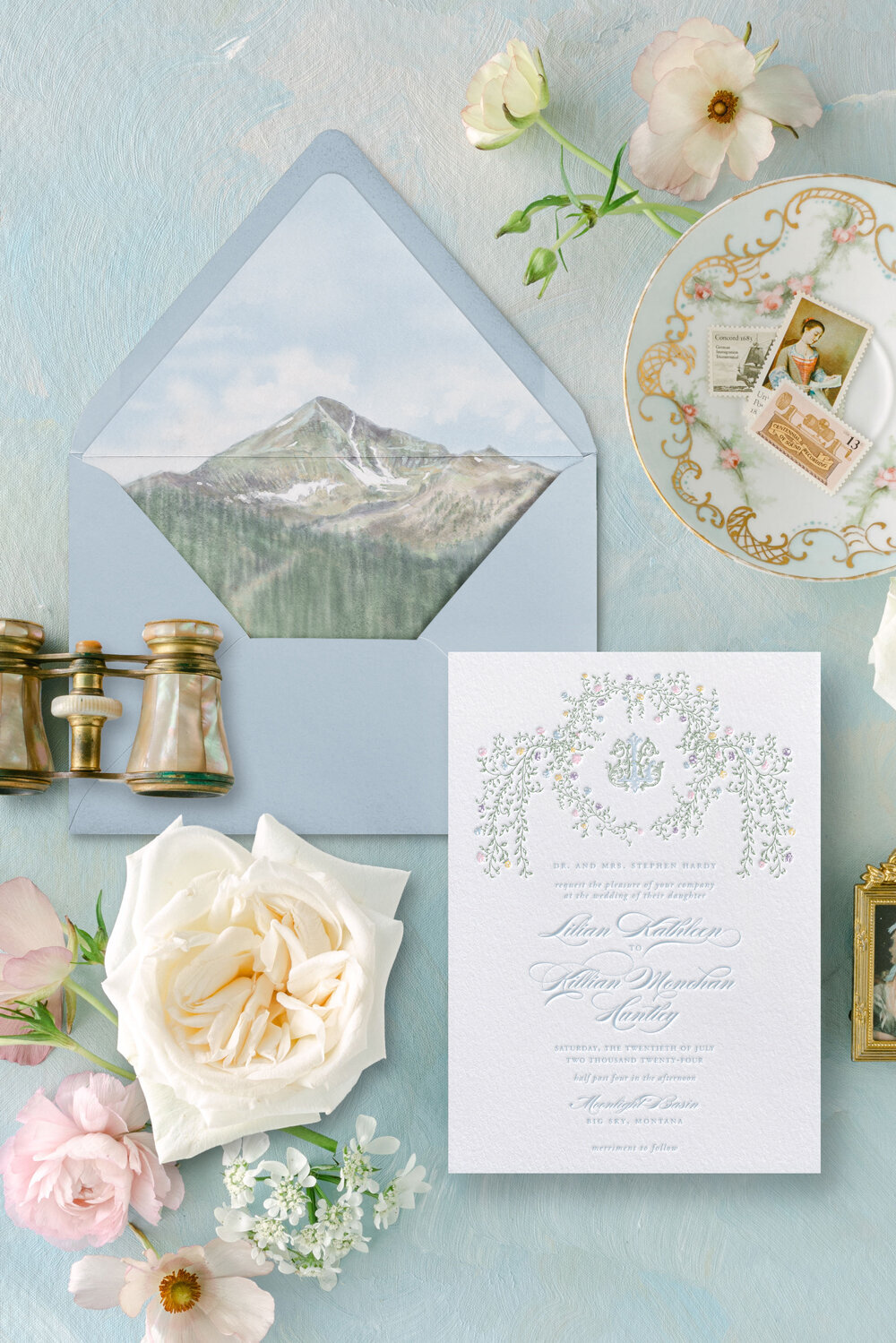 Custom watercolor venue wedding invitation suite with vintage monogram and floral border, featuring a Lone Mountain envelope liner for a Mountain Luxury meets Garden Party wedding at Moonlight Basin