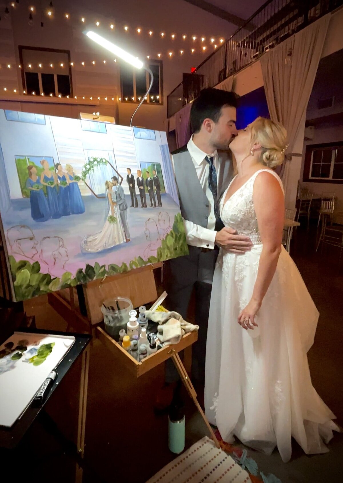Bride and groom watching a live painting at their wedding reception in Sioux Falls, South Dakota