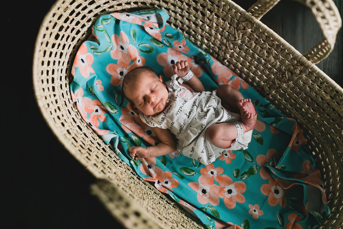 Newborn photography of a baby sleeping in bed.
