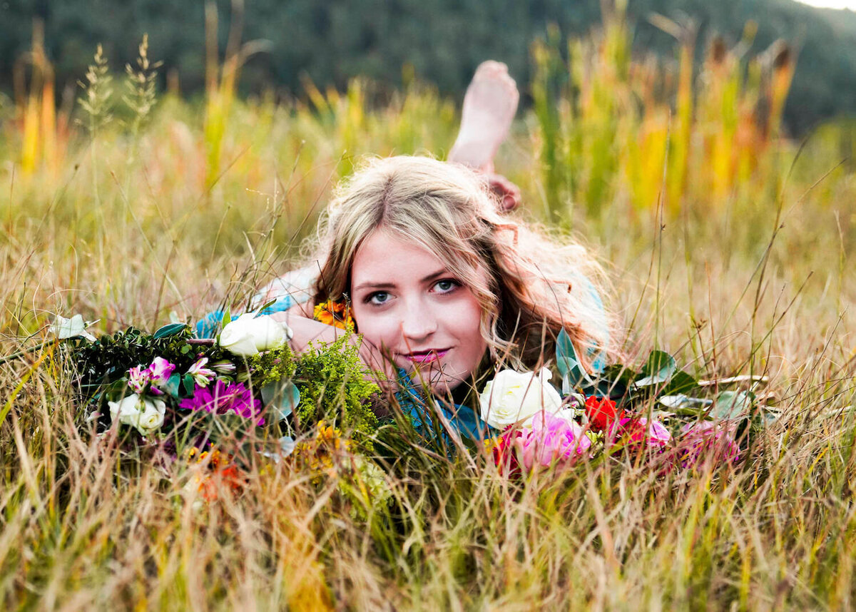 senior photography denver - teen girl laying in field