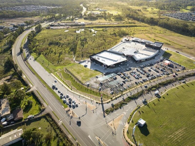 Aerial view of Carmel Village Shopping Centre layout including main building, parking areas, and surrounding development. 