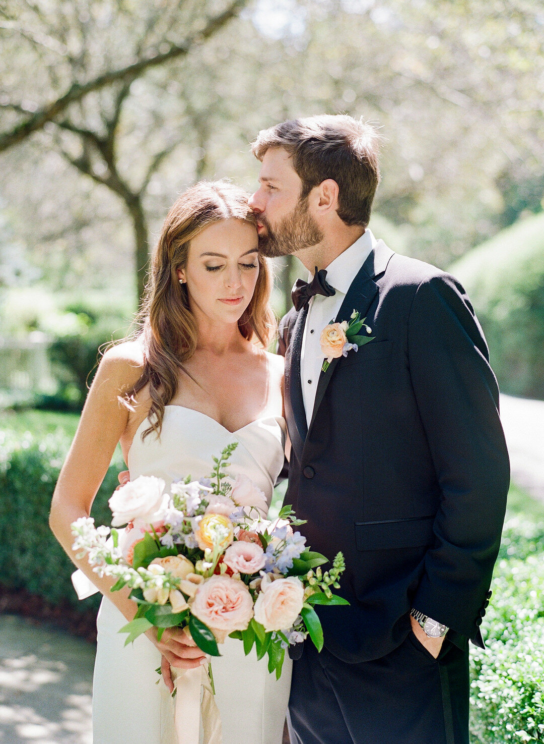 groom kissing bride on forehead