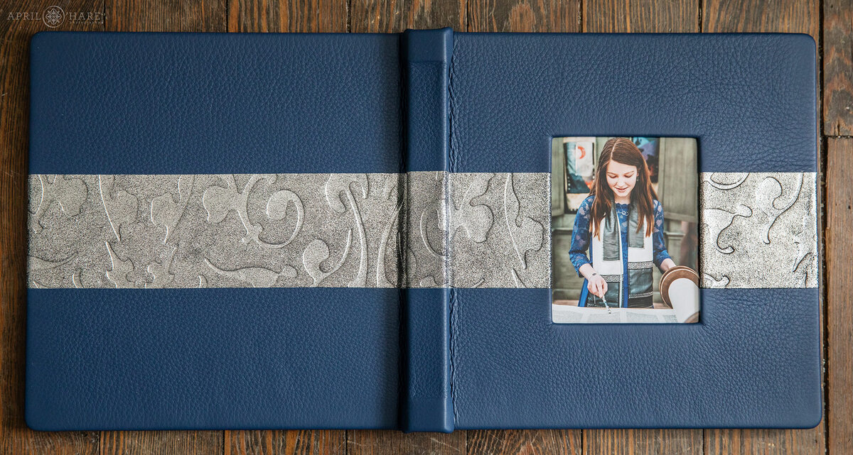 Blue 10 Inch by 10 inch Bat Mitzvah Album with a Blue leather cover and a swirly silver leather stripe