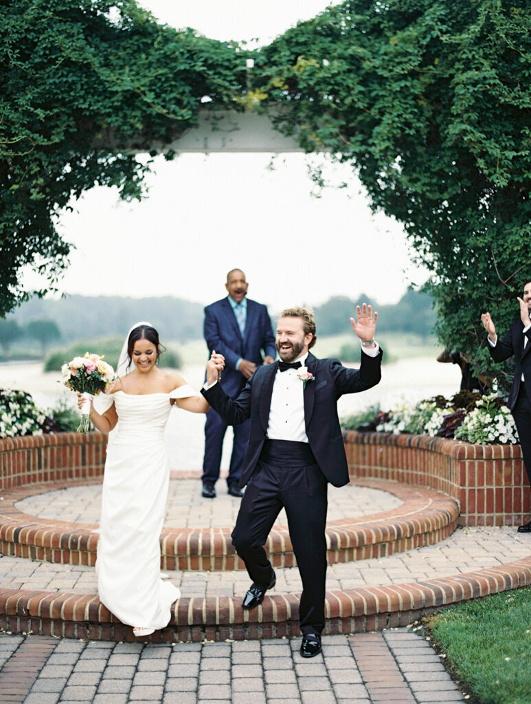 Couple celebrating exiting their ceremony taken by one of the top washington dc wedding photographer Nicole Simensky
