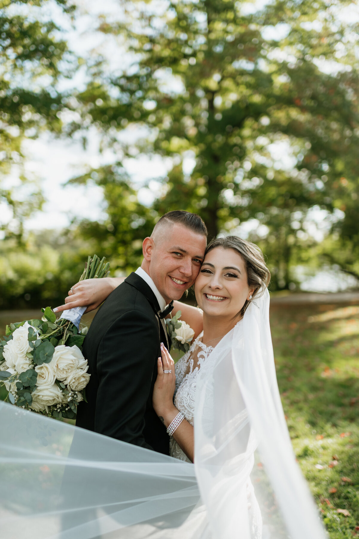 Bride and groom hugging outdoor portrait