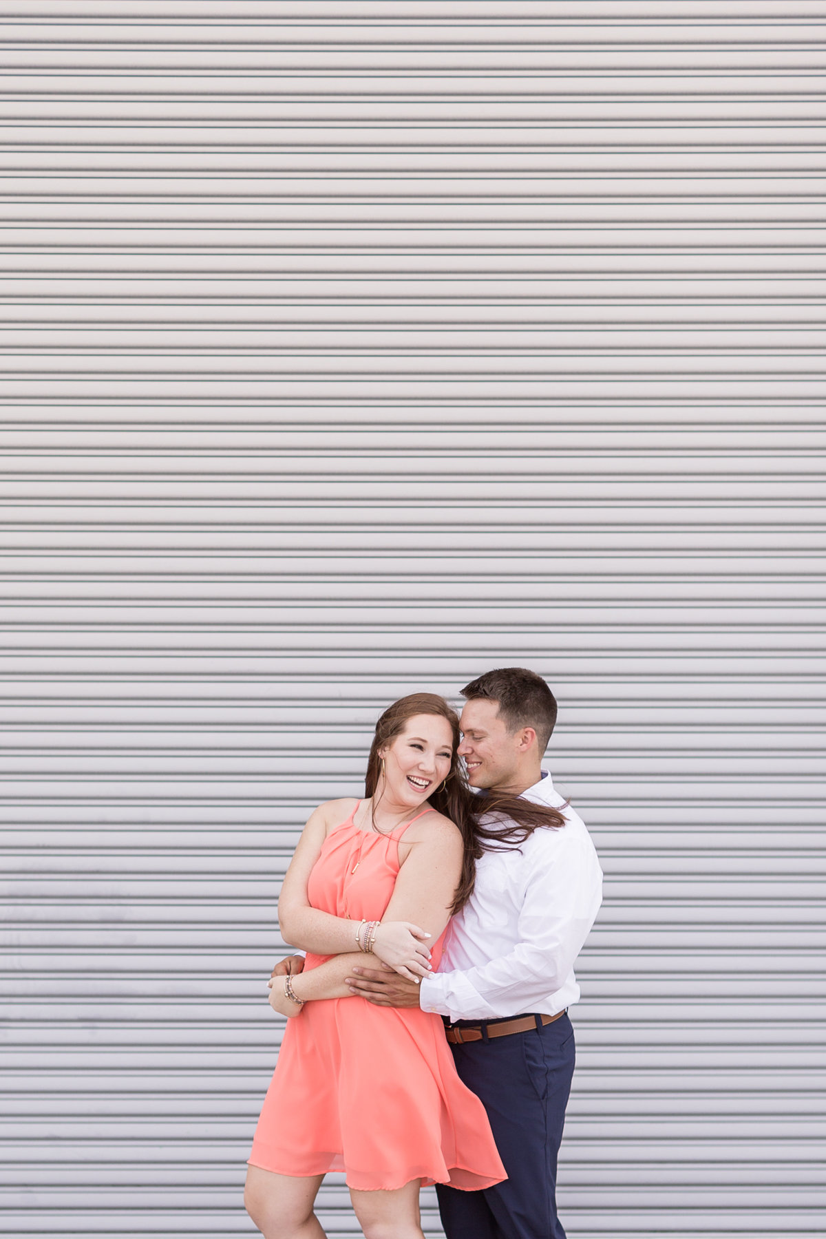 Meghan & Austin embrace during their engagement session in downtown Mobile, Alabama.