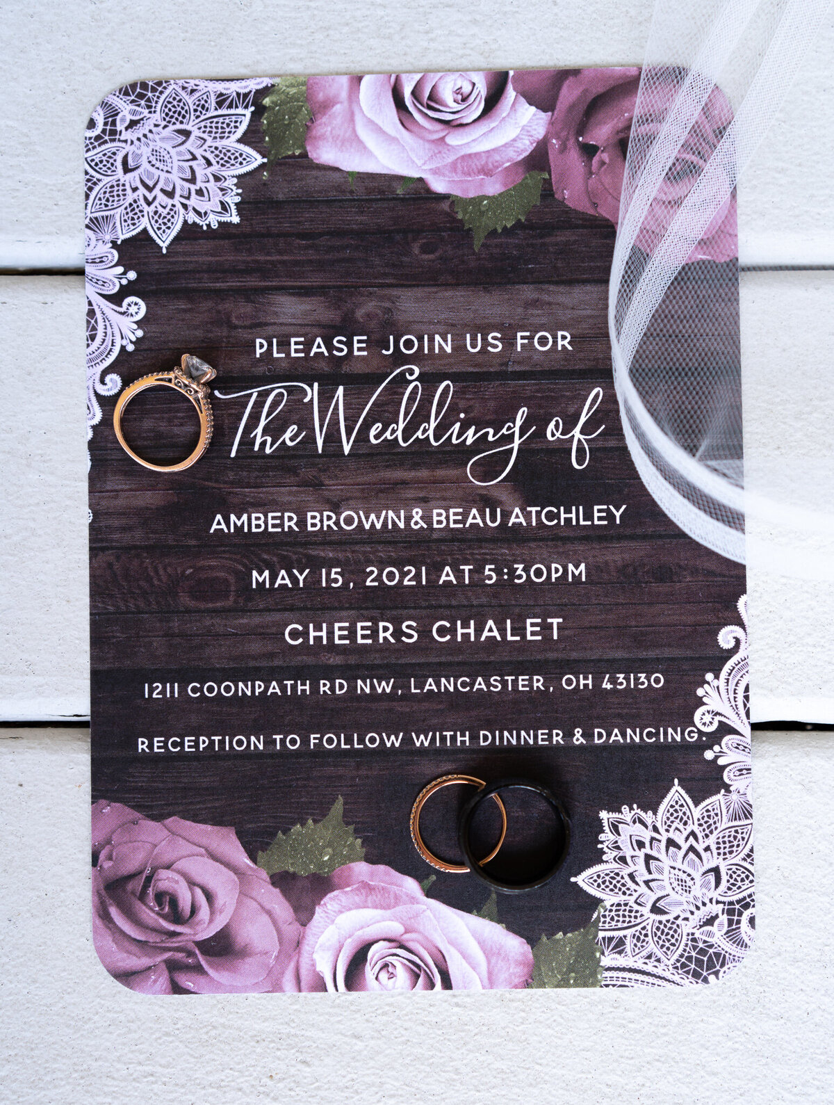 The invitation and rings for Amber and Beau Atchley's wedding at Cheers Chalet in Lancaster, Ohio.