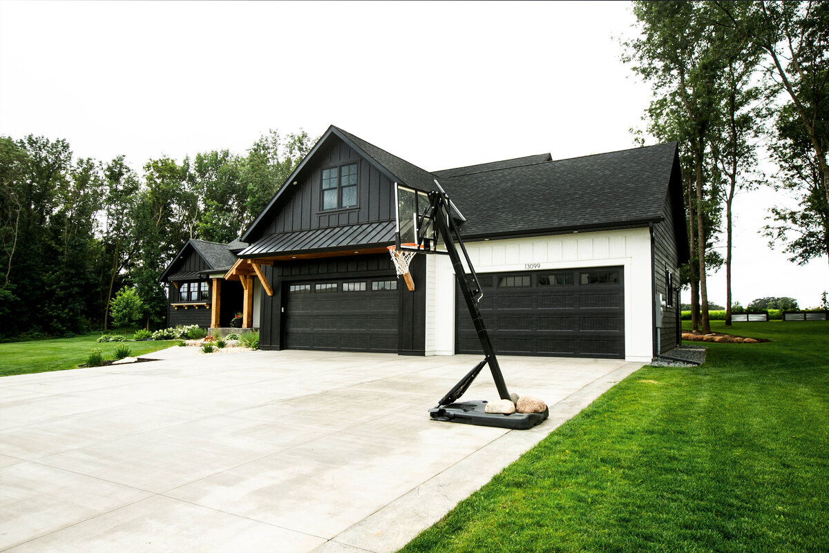 Exterior view of custom home in Otsego, Minnesota with modern details and front porch built by Cornerstone Custom Builds
