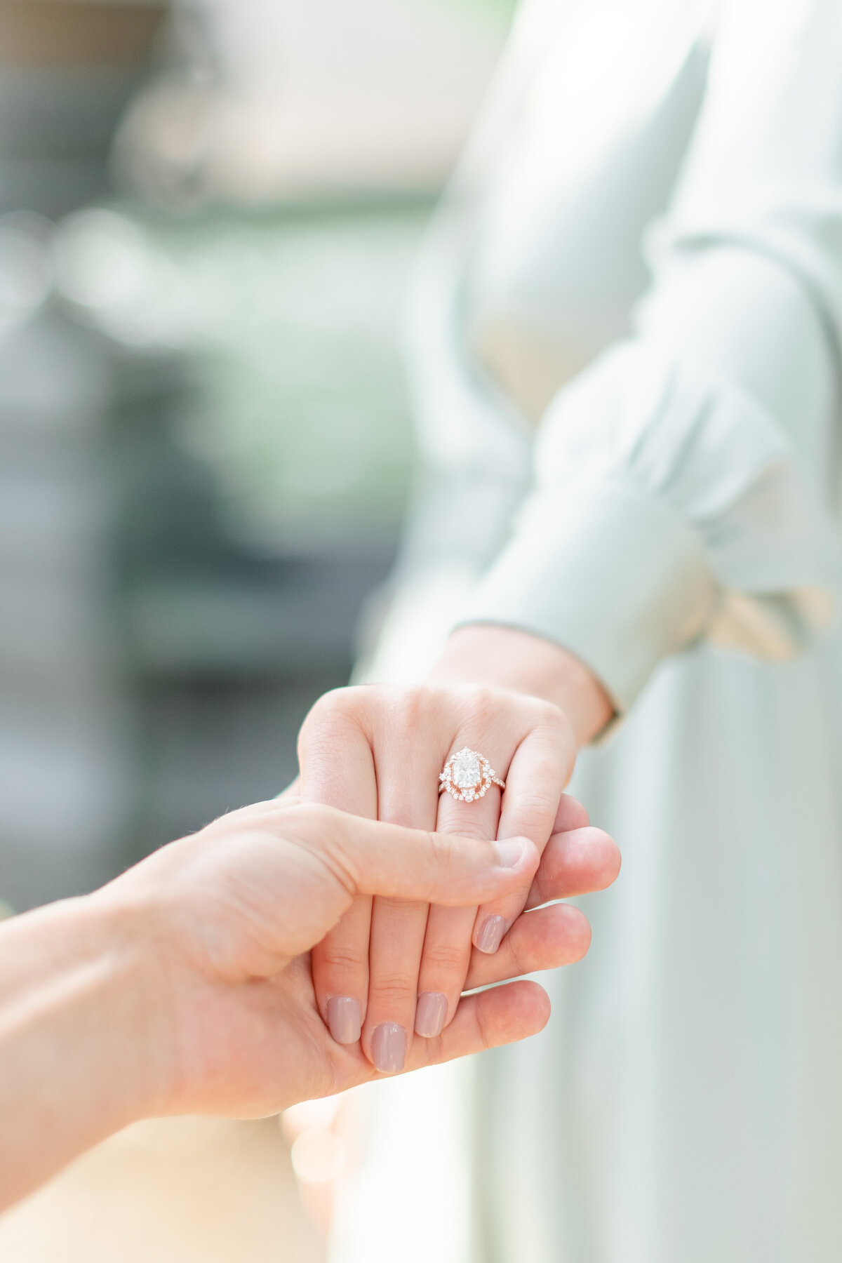 couple holding hands and photo of a ring by wedding photographers fort myers