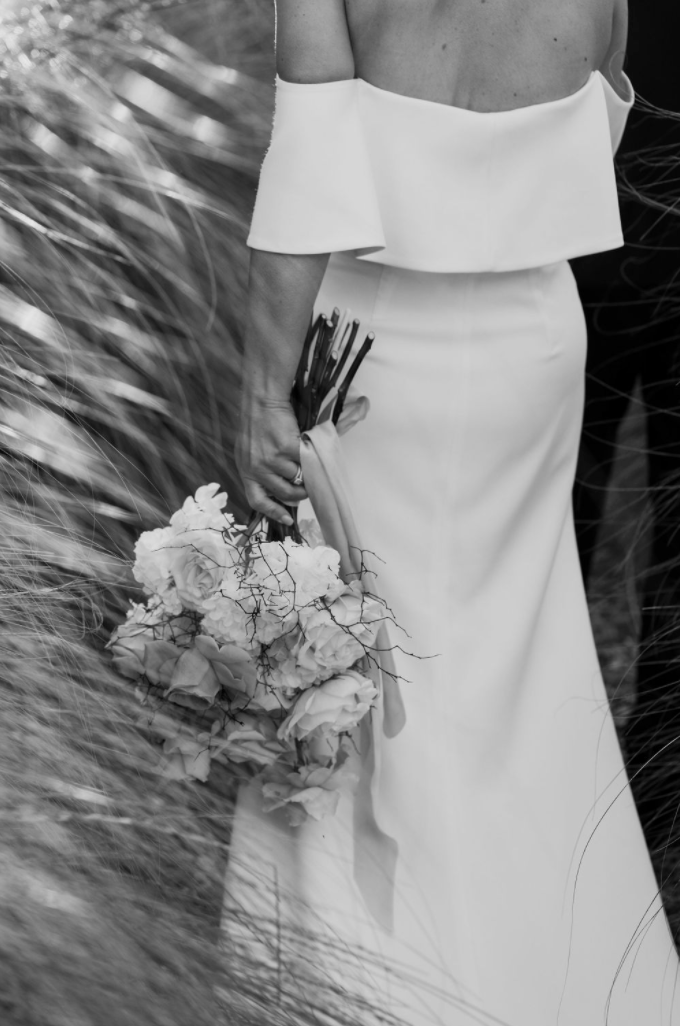 The Lovers Elopement Co - black and white photo of bride holding bouquet