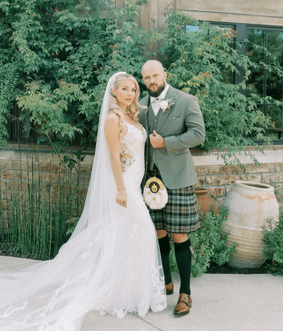 Elegant bride with styled curls and groom in kilt after receiving Austin wedding hair, makeup, and men's grooming services