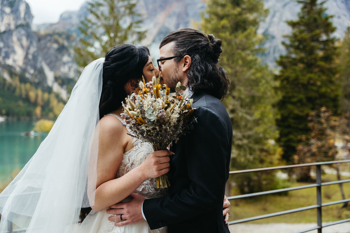 Couple standing together by Lake Braies with mountains
