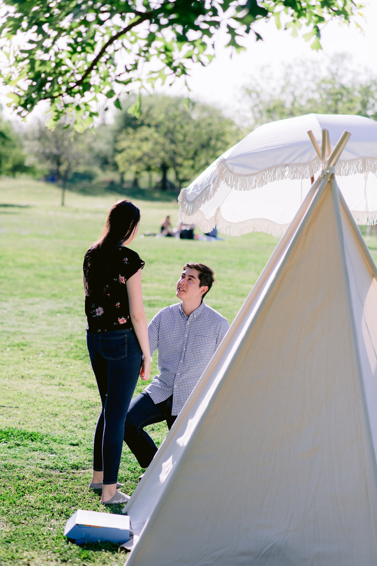 Proposal ideas in Austin man on one knee outside of tent