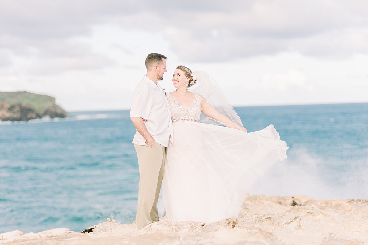 bride and groom on the cliffside of kauai