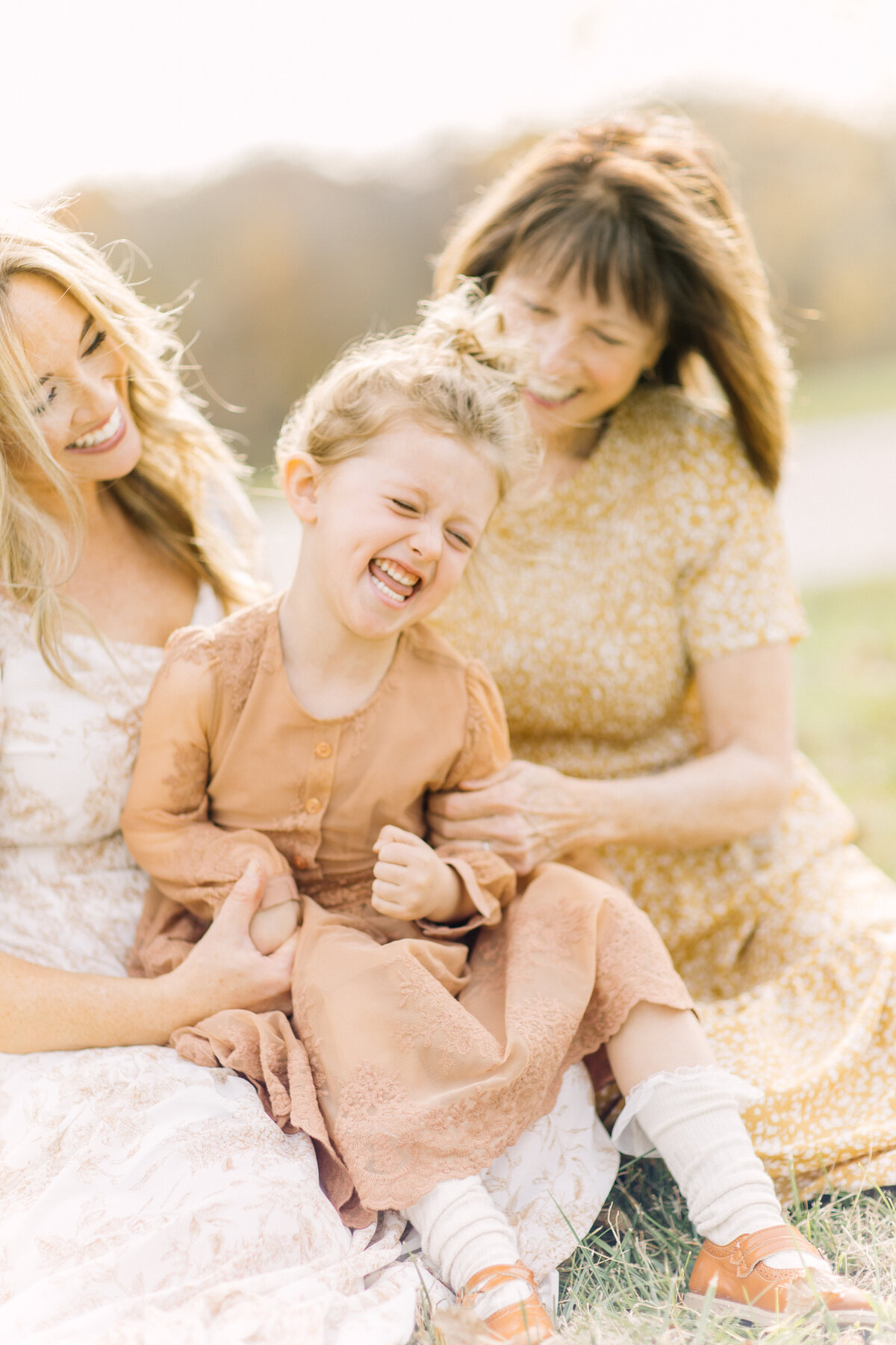 Mother, daughter, and grandmother laughing together