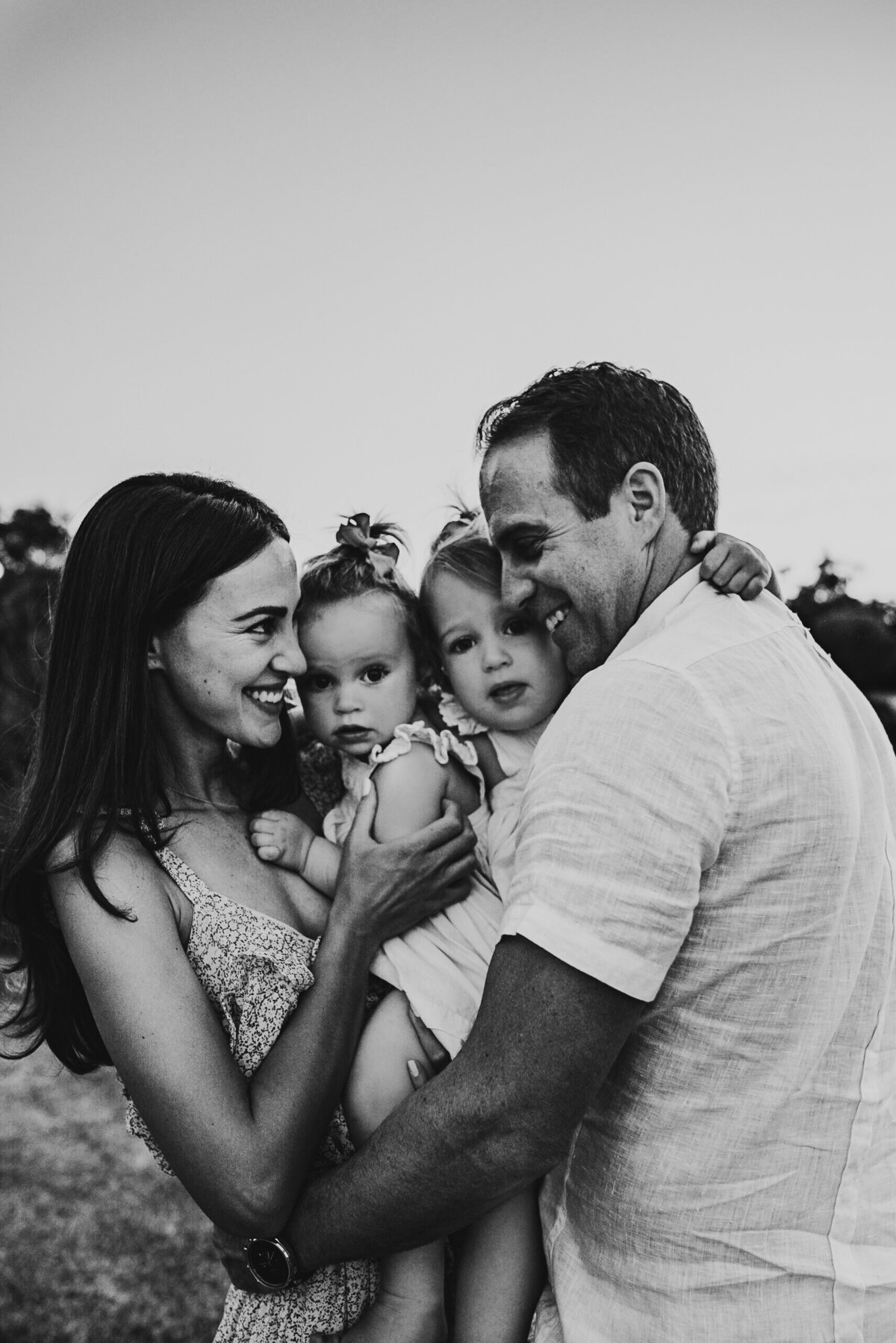 family standing close and  lovingly smiling  - a sunset family fremantle photographe session  | gracie and the Wren