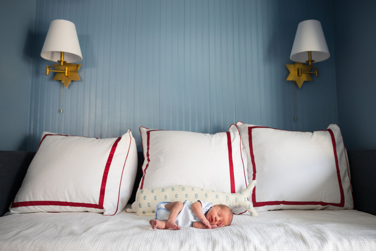melinda chesson interiors west 7th street nursery blue painted walls and bed with red striped pillows