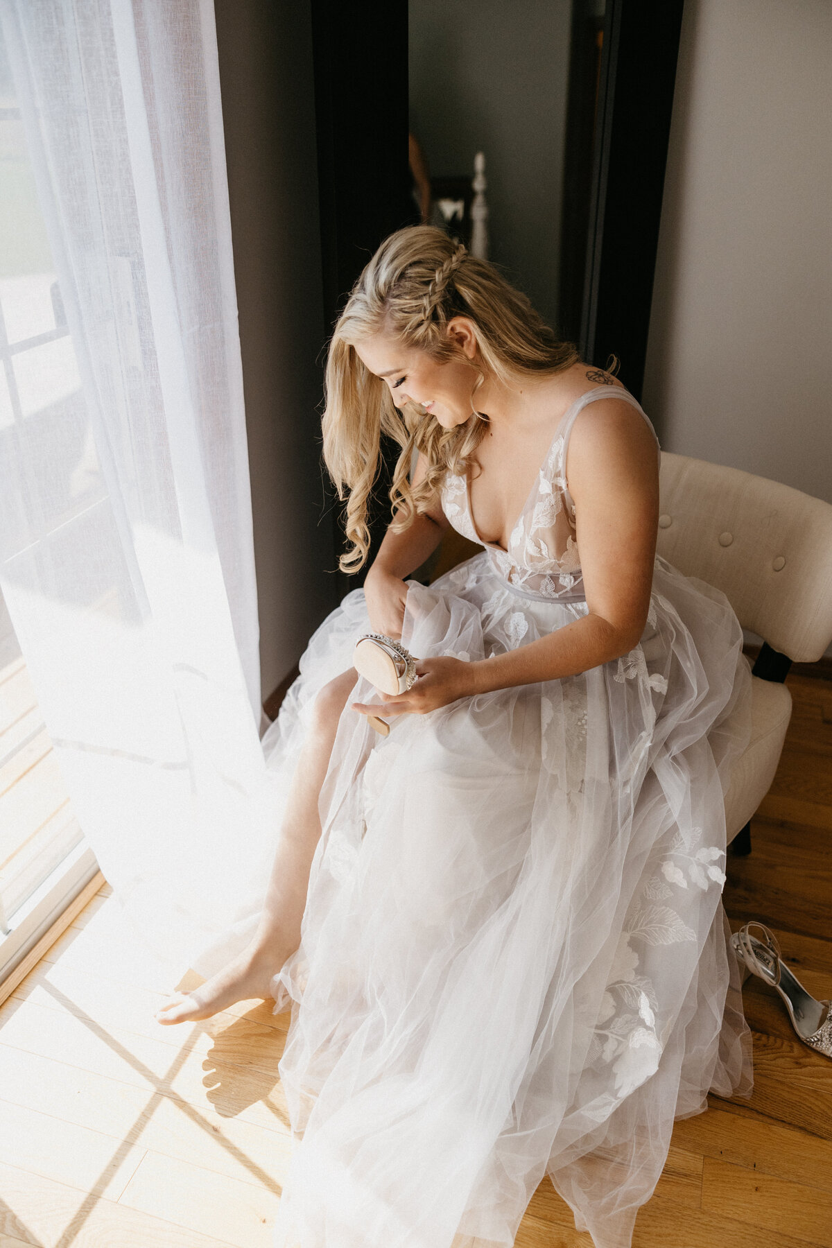 bride putting on wedding shoes for wedding day
