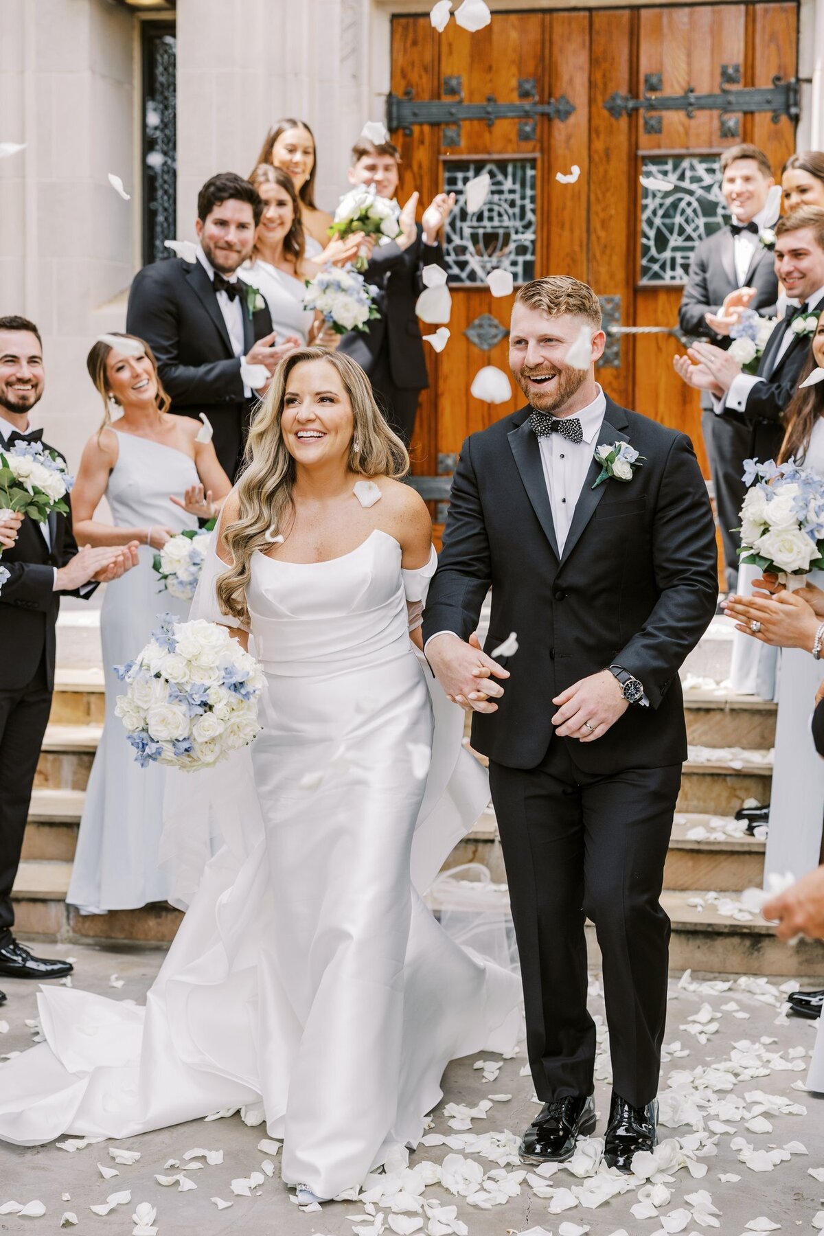Bride and Groom holding hands leaving church