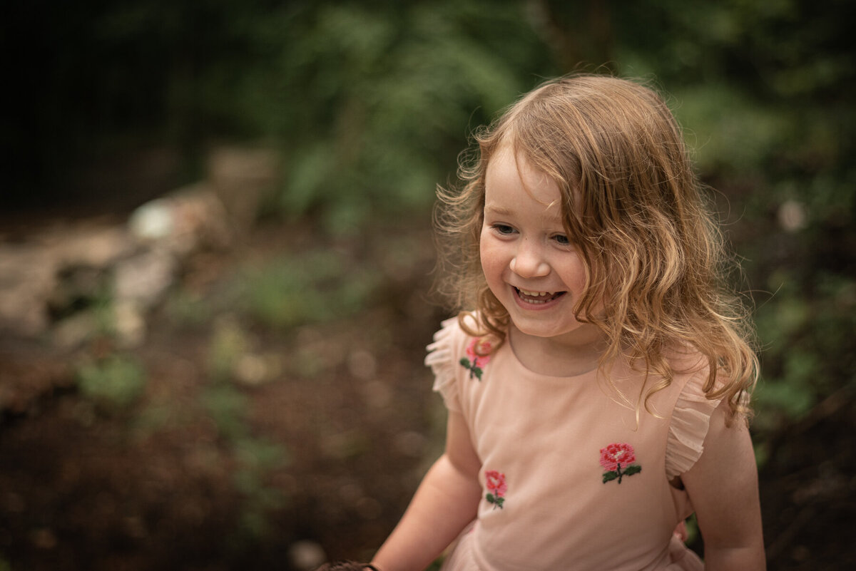 A baby girl sits wrapped in a blanket at Meads Quarry.