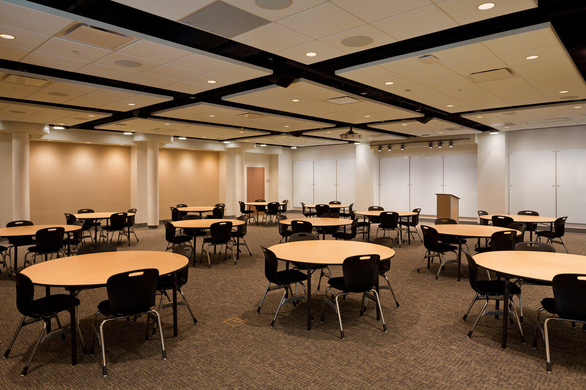 inside the multipurpose room at Trinity School with tables and chairs and folding wall partitions