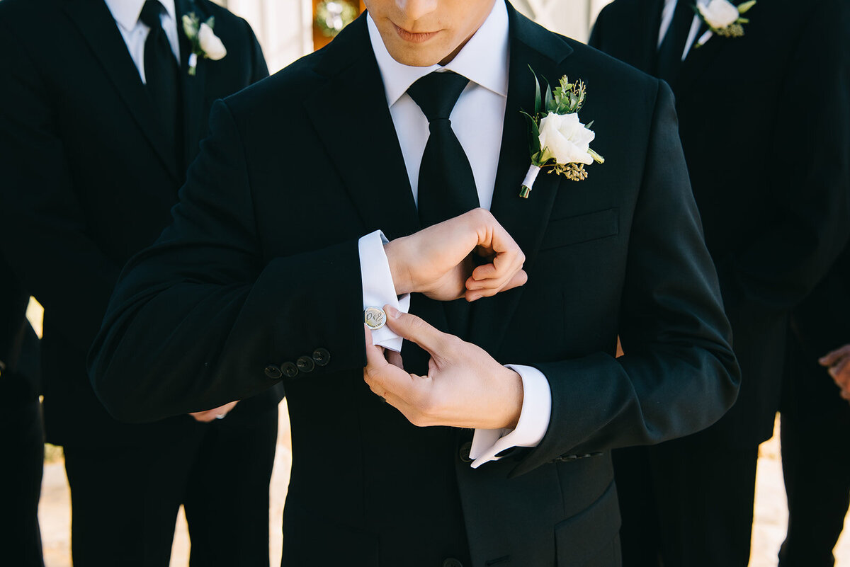 Groom with white and green boutonniere designed by Abby Grace Florals at Saluda SC wedding