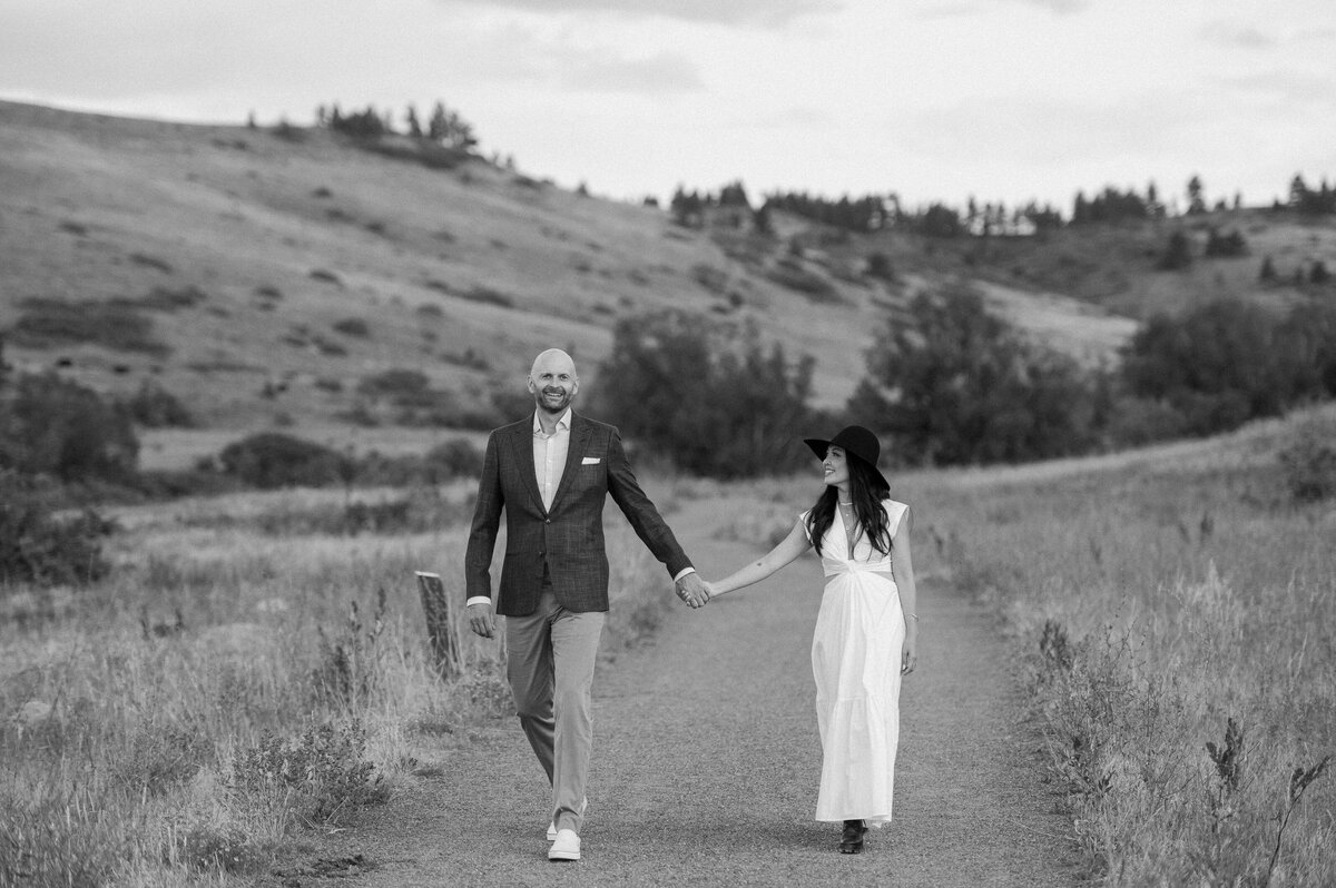 Black and white photo of a couple holding hands for their Boulder engagement session