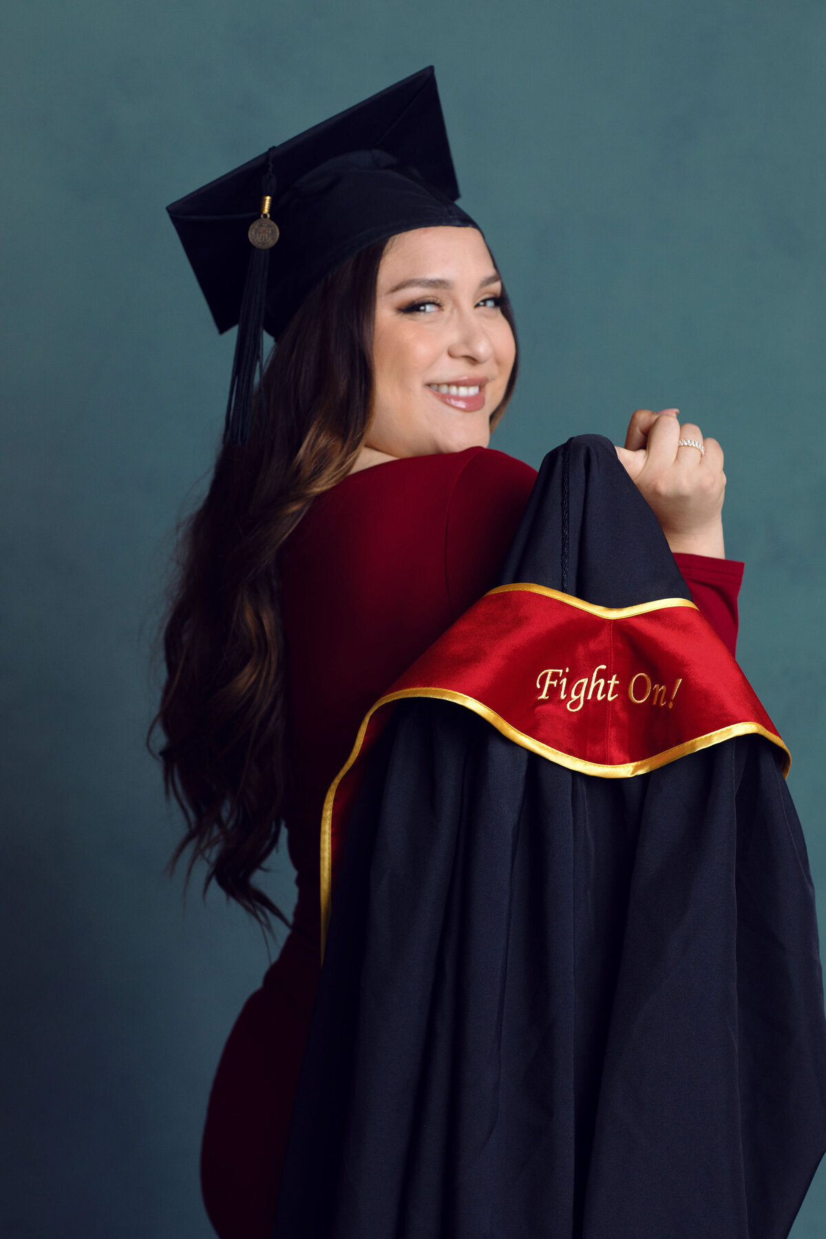 Graduation Portrait Of Young Woman Showing Her Black Toga Los Angeles