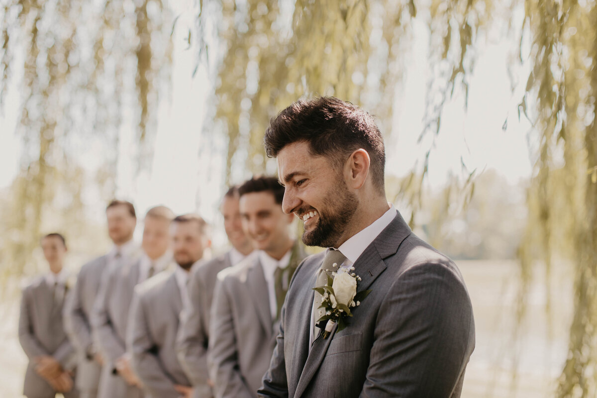 Groom excited to see his bride walking down the aisle. 