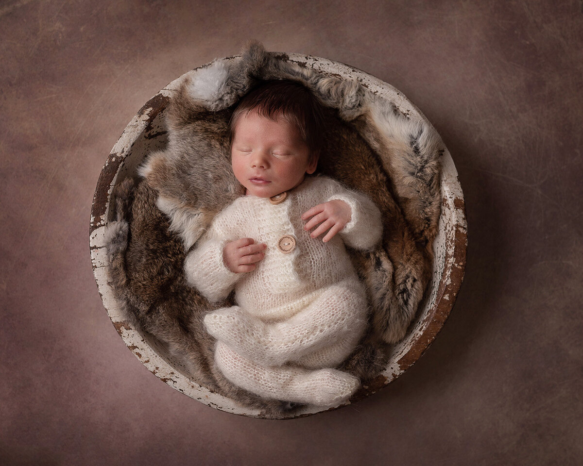 Adorable newborn photo in a bucket