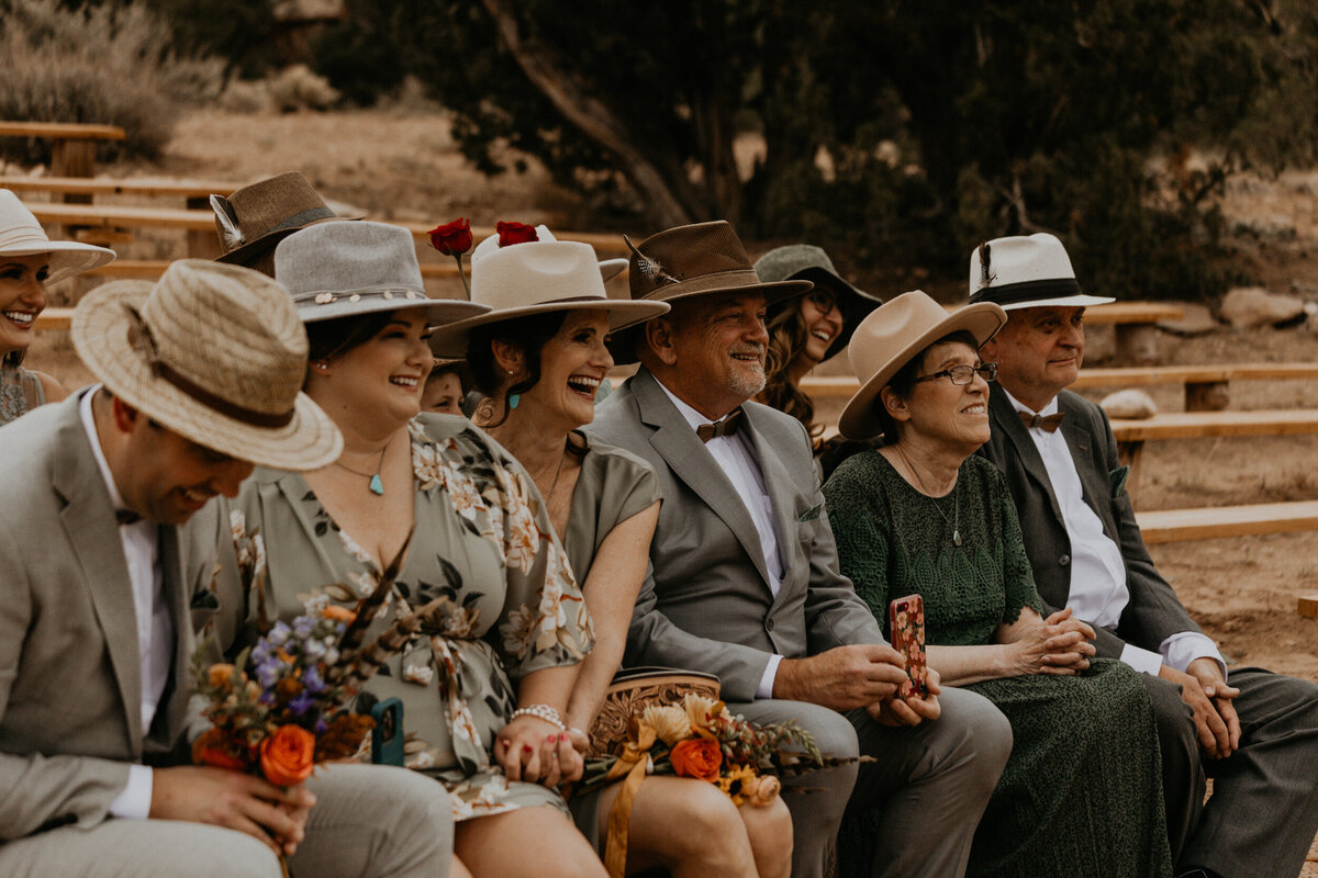wedding guests wearing hats during intimate wedding ceremony