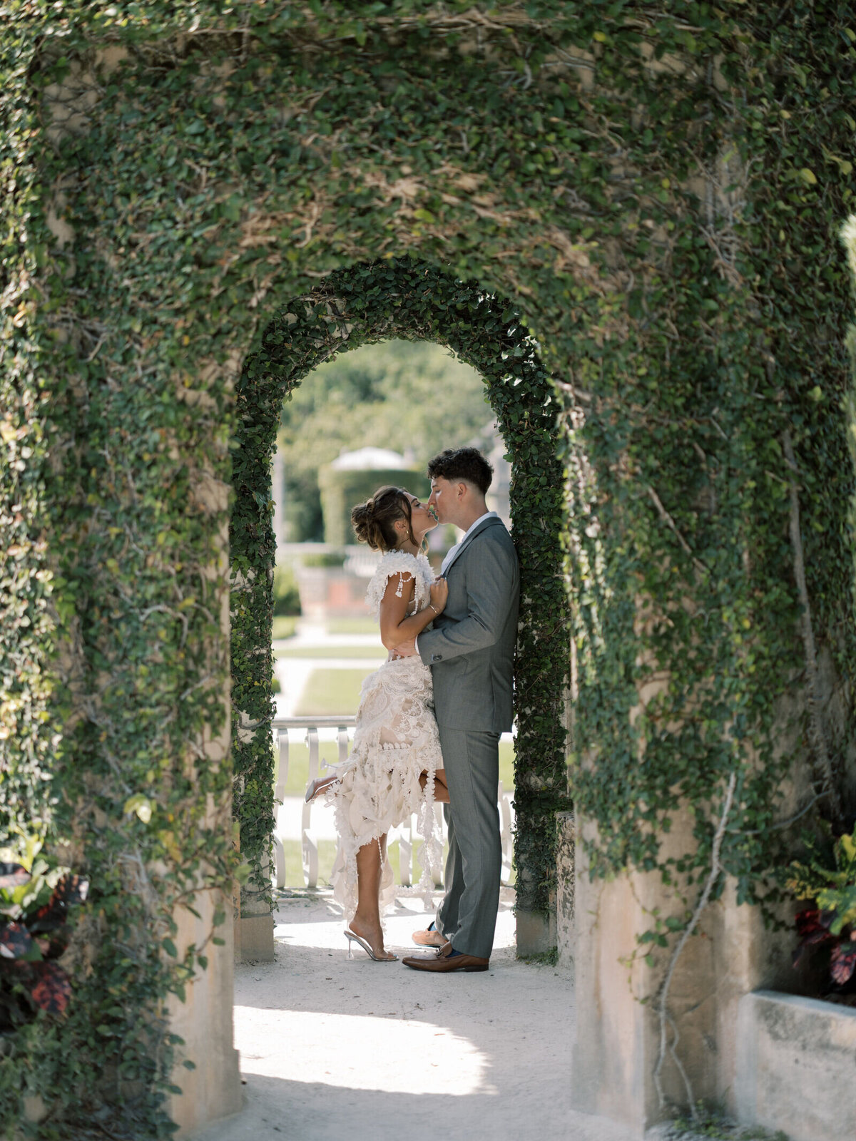 vizcaya-engagement-kiss-under-garden-arch