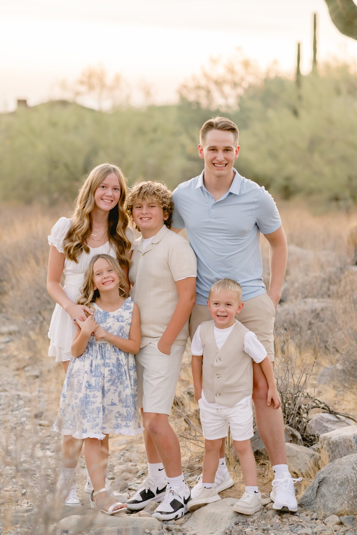 5 kids standing in the arizona desert smiling at the camera