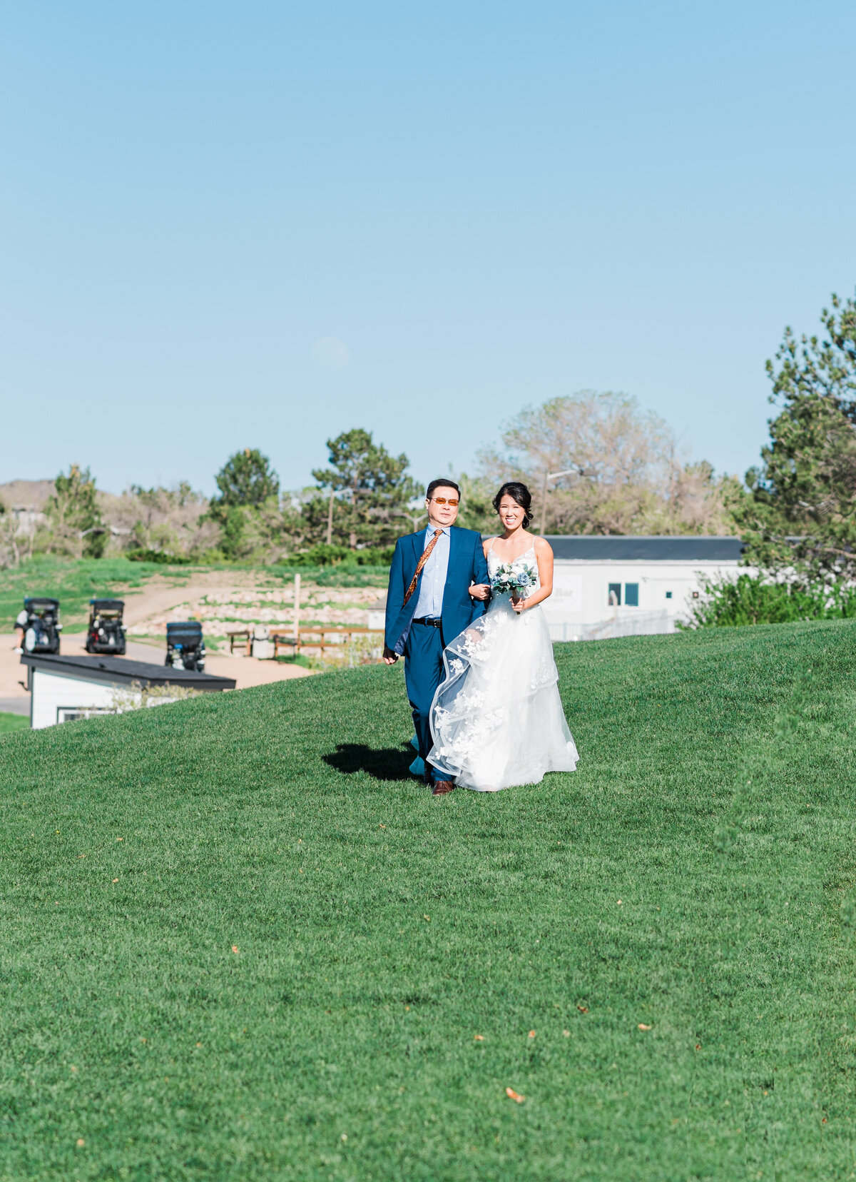 Denver wedding photographer captures bride and her father walking down to the alter to get married at The Oaks venue
