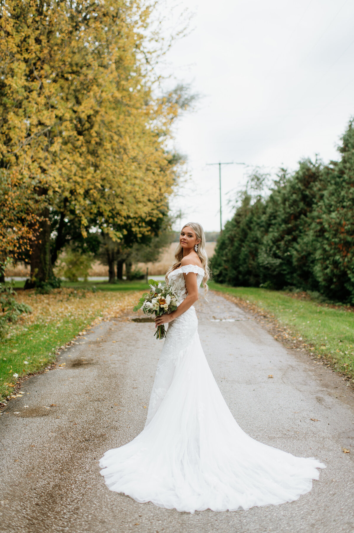 Bride walking down tree-lined driveway South Bend
