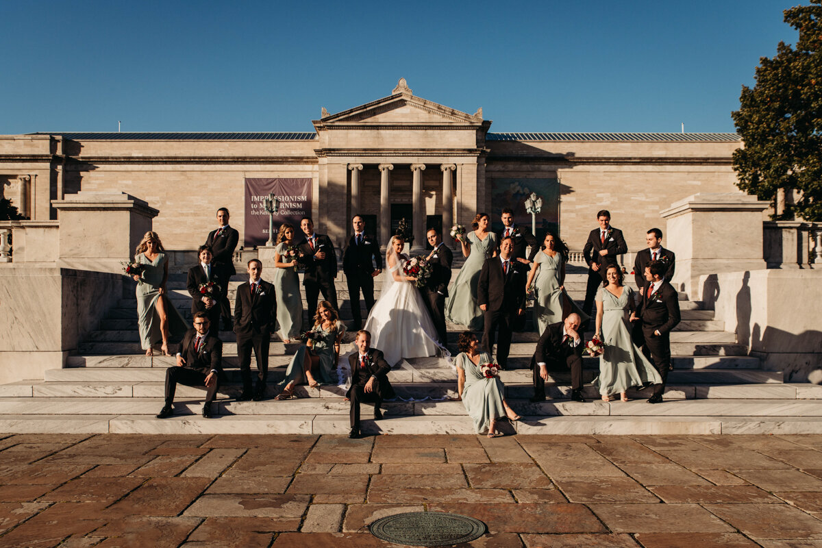 Large wedding party pose editorial on steps of Cleveland Museum of Art