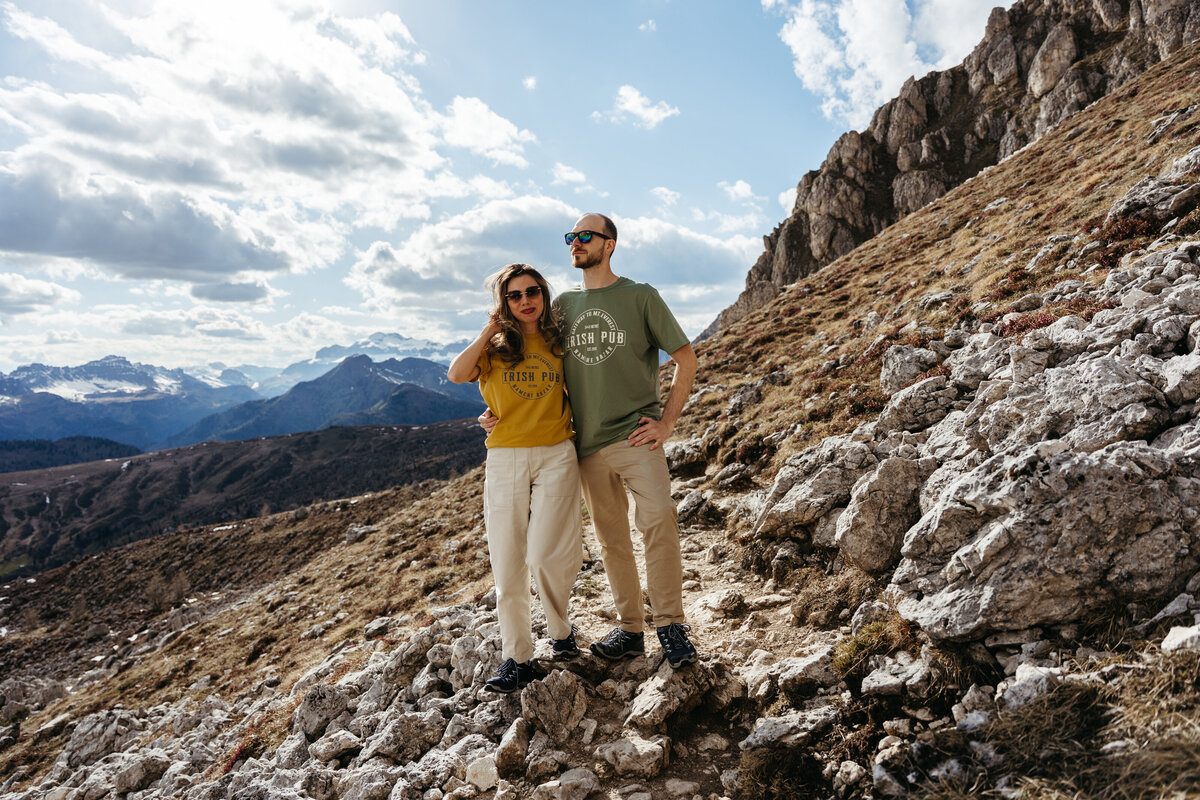 Couple standing together with mountain views behind them