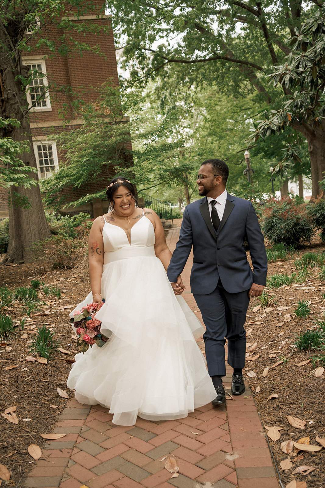 spouses laughing and walking together in park richmond virginia