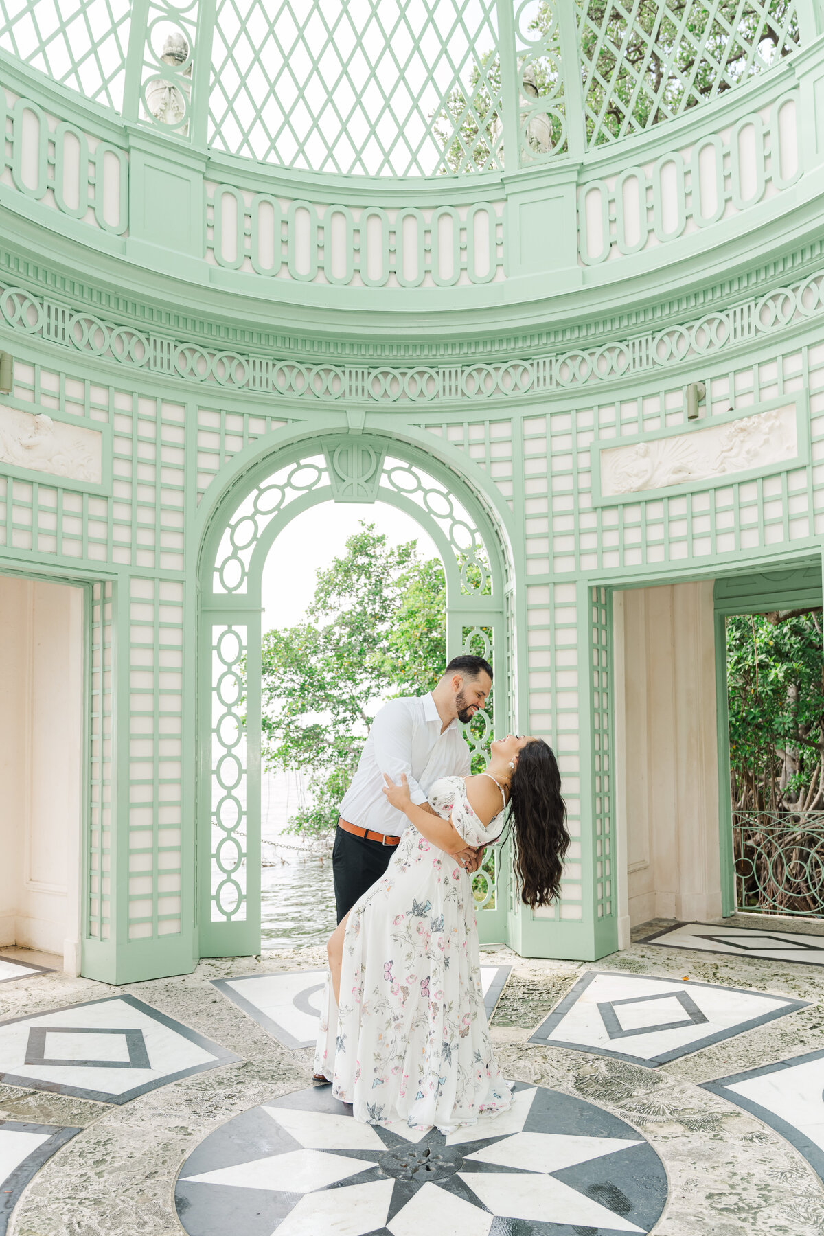 a couple dip kissing  at the vizcaya museum in miami