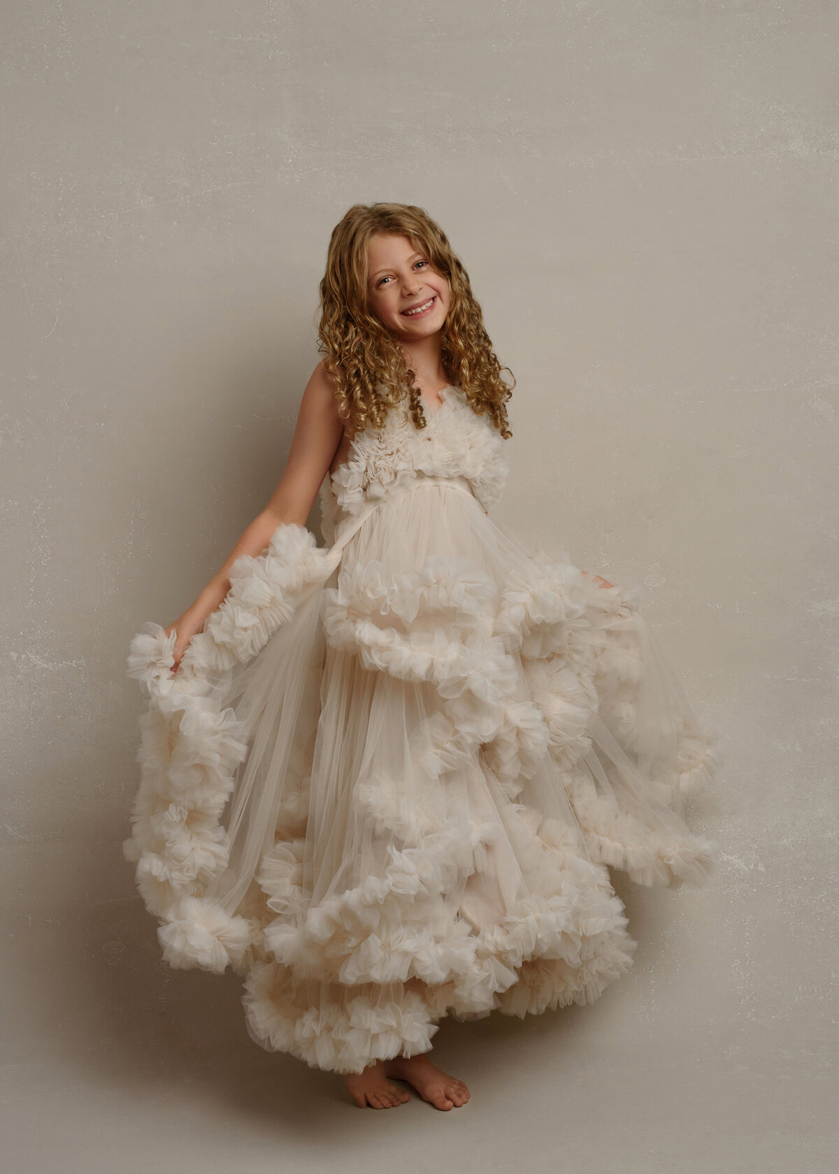 fine art child standing in studio couture gown