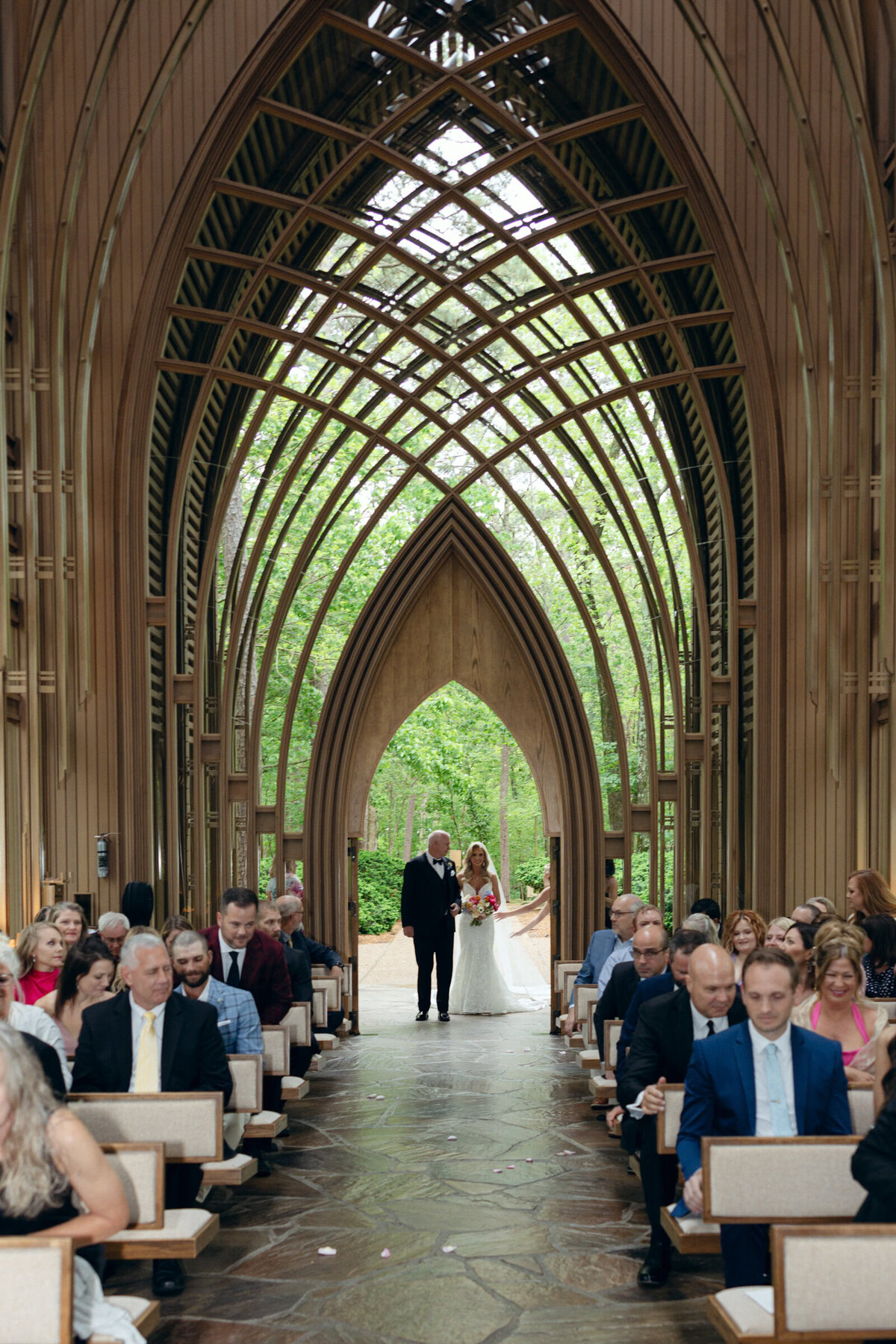 A wedding day photo of the bride walking down the aisle