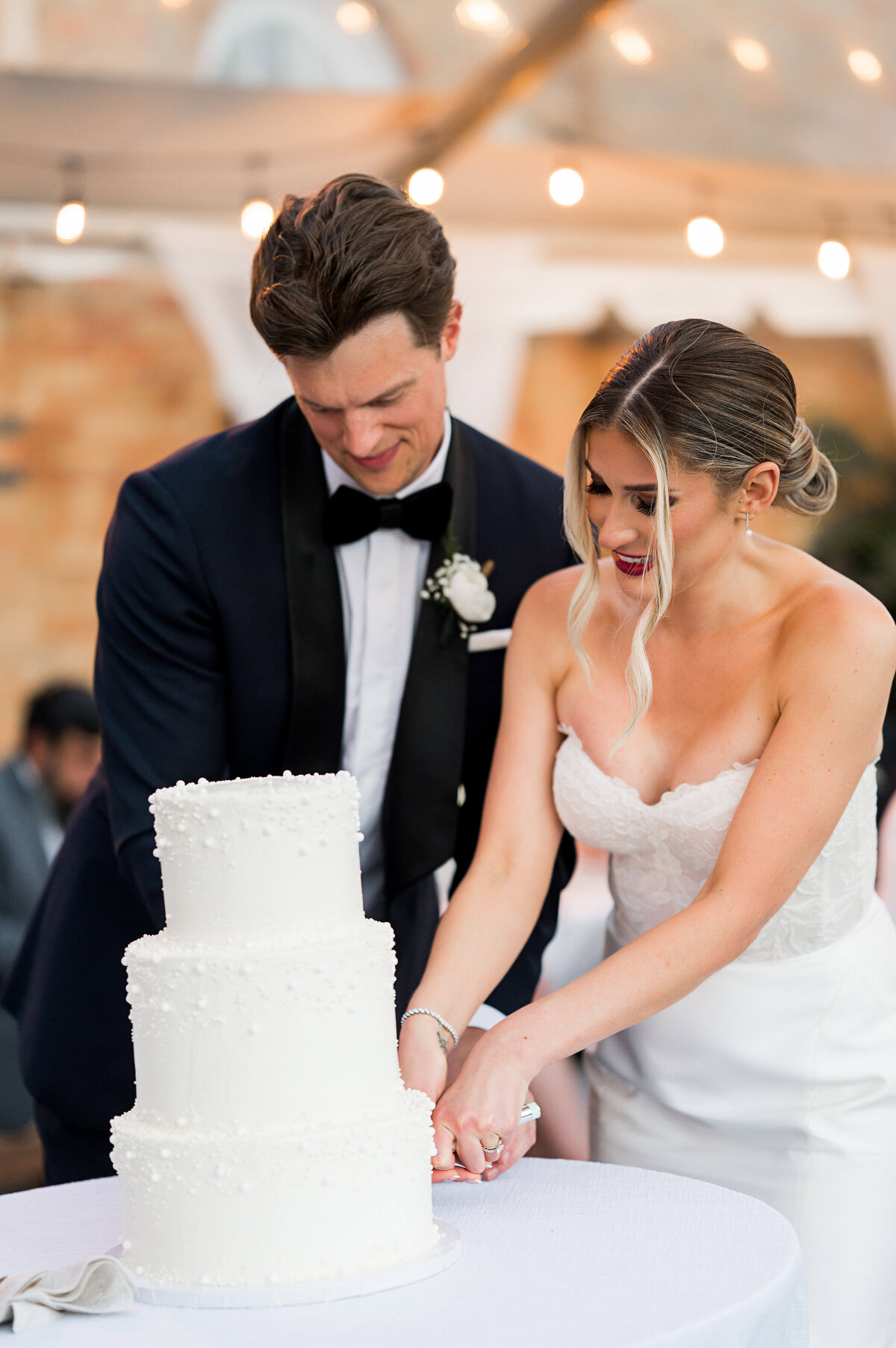 bride and groom cutting their wedding cake