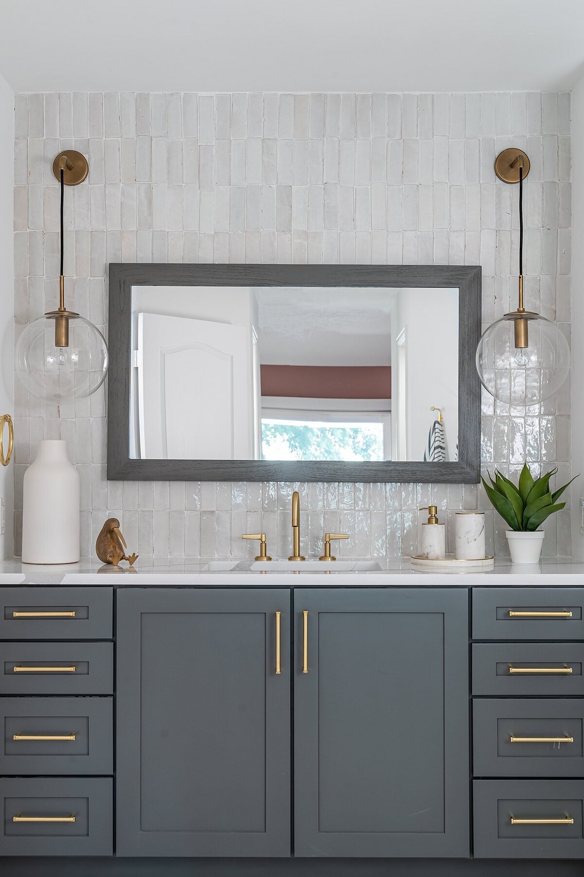 coastal luxury home Master Bathroom gray vanity and mirror full service interior design by Island Home Interiors Lake Nona