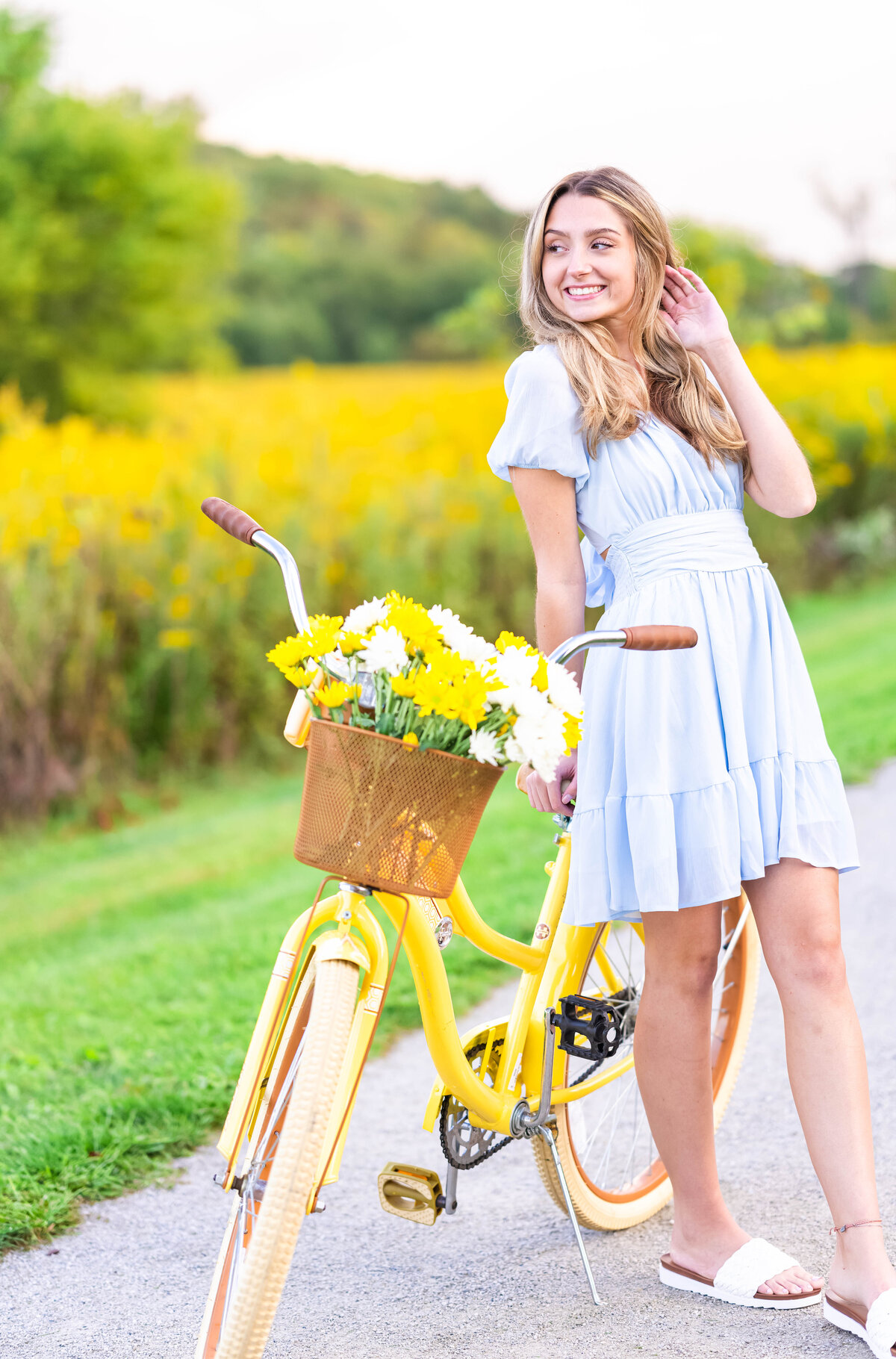 high school senior girl with bicycle smiling