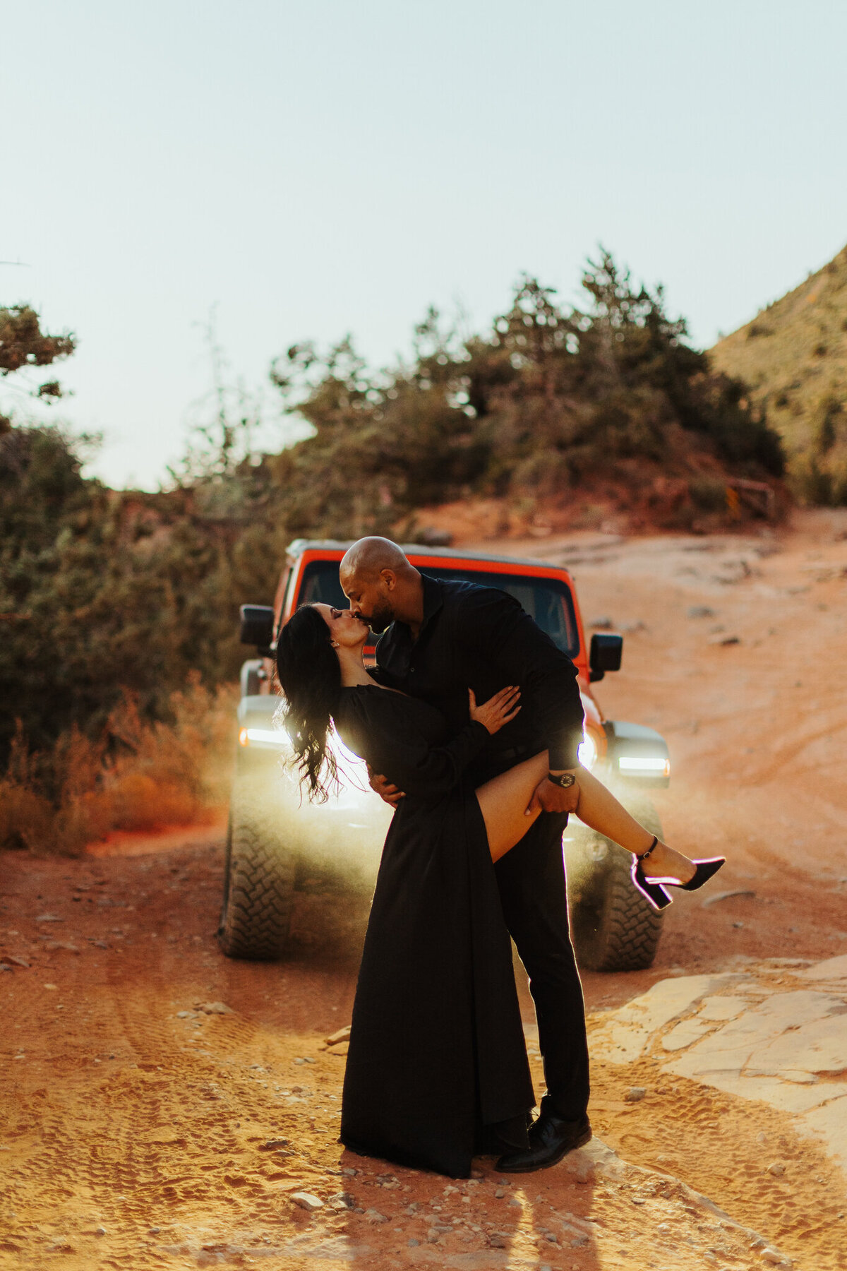mana dn woman kiss in front of jeep for adventure engagement photos in sedona